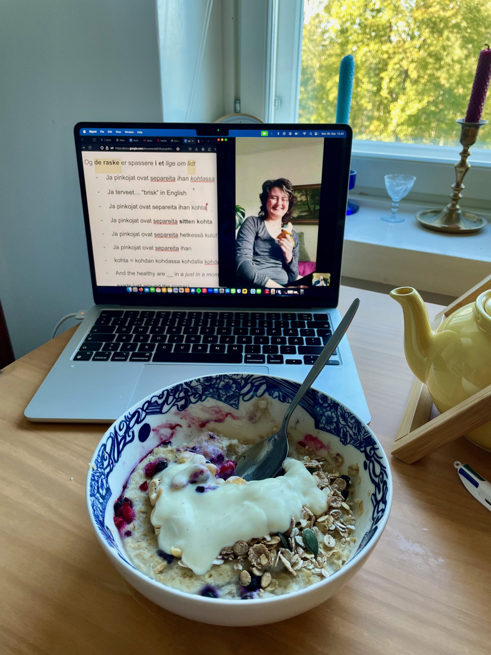 Photo of breakfast and a computer that has open a video call with a colleague.